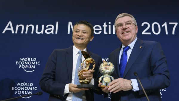 Alibaba Group Founder and Executive Chairman, China's Jack Ma (L) poses next to International Olympic Comittee (IOC) president Thomas Bach as they exchange gifts during the anouncement of a long-term partnership of Alibaba as worldwide sponsor on the sideline of the Forum's annual meeting, on January 19, 2017 in Davos Alibaba Group Founder and Executive Chairman, China's Jack Ma (L) poses next to International Olympic Comittee (IOC) president Thomas Bach as they exchange gifts during the anouncement of a long-term partnership of Alibaba as worldwide sponsor on the sideline of the Forum's annual meeting, on January 19, 2017 in Davos - Sputnik International