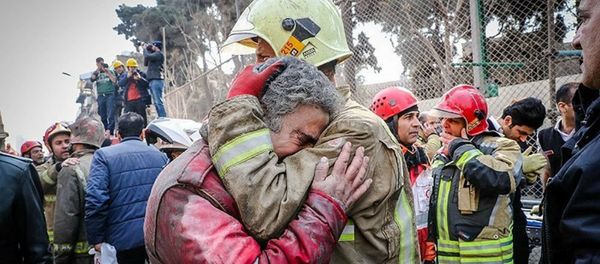 Firefighters react at the site of a collapsed high-rise building in Tehran, Iran January 19, 2017 Firefighters react at the site of a collapsed high-rise building in Tehran, Iran January 19, 2017 - Sputnik International