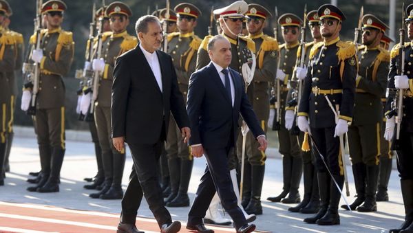 In this photo released by official website of the office of the Iranian Senior Vice-President, Syrian Prime Minister Imad Khamis, right, reviews honor guard as he is accompanied by Iranian Senior Vice-President Eshagh Jahangiri, during his official welcoming ceremony in Saadabad palace in Tehran, Iran, Tuesday, Jan. 17, 2017 - Sputnik International