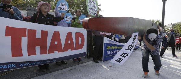 Protesters carry a mock missile symbolizing an advanced U.S. missile defense system called Terminal High-Altitude Area Defense, or THAAD, during a rally to oppose a plan to deploy the THAAD in front of the Defense Ministry in Seoul, South Korea, Thursday, Oct. 20, 2016 Protesters carry a mock missile symbolizing an advanced U.S. missile defense system called Terminal High-Altitude Area Defense, or THAAD, during a rally to oppose a plan to deploy the THAAD in front of the Defense Ministry in Seoul, South Korea, Thursday, Oct. 20, 2016 - Sputnik International
