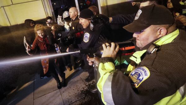 Police unleash pepper spray on protestors during an altercation on 14th Street ahead of the presidential inauguration, Thursday, Jan. 19, 2017, in Washington Police unleash pepper spray on protestors during an altercation on 14th Street ahead of the presidential inauguration, Thursday, Jan. 19, 2017, in Washington - Sputnik International