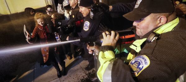 Police unleash pepper spray on protestors during an altercation on 14th Street ahead of the presidential inauguration, Thursday, Jan. 19, 2017, in Washington Police unleash pepper spray on protestors during an altercation on 14th Street ahead of the presidential inauguration, Thursday, Jan. 19, 2017, in Washington - Sputnik International