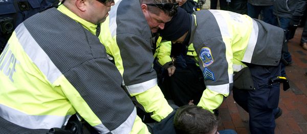 Police try to remove a demonstrator from attempting to block people entering a security checkpoint, Friday, Jan. 20, 2017, ahead of President-elect Donald Trump's inauguration in Washington Police try to remove a demonstrator from attempting to block people entering a security checkpoint, Friday, Jan. 20, 2017, ahead of President-elect Donald Trump's inauguration in Washington - Sputnik International