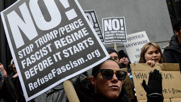 A woman holds an anti-Trump sign during inauguration protests in New York City. - Sputnik International