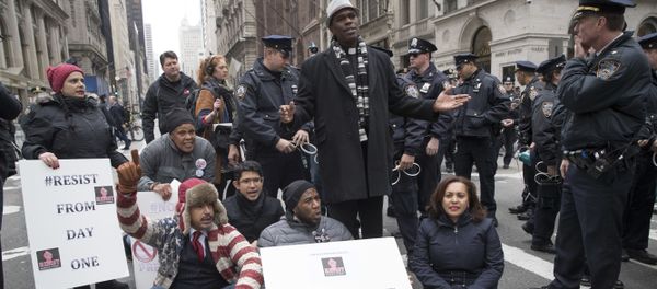 Police officers prepare to take New York City Councilman Jumaane Williams, center, into custody after he and others blocked traffic on Fifth Avenue outside Trump Tower in New York, Friday, Jan. 20, 2017, during a protest during President Donald Trump's inauguration. - Sputnik International