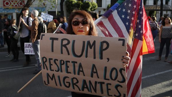 A woman holds a sign that reads in Spanish Trump, respect migrants during a march called by a local women's movement against U.S. President Donald Trump in Mexico City, Friday, Jan. 20, 2017 A woman holds a sign that reads in Spanish Trump, respect migrants during a march called by a local women's movement against U.S. President Donald Trump in Mexico City, Friday, Jan. 20, 2017 - Sputnik International