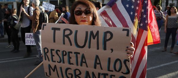 A woman holds a sign that reads in Spanish Trump, respect migrants during a march called by a local women's movement against U.S. President Donald Trump in Mexico City, Friday, Jan. 20, 2017 - Sputnik International