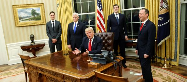 U.S. President Donald Trump, flanked by Senior Advisor Jared Kushner (standing, L-R), Vice President Mike Pence, Staff Secretary Rob Porter and Chief of Staff Reince Priebus, welcomes reporters into the Oval Office for him to sign his first executive orders at the White House in Washington, U.S. January 20, 2017 - Sputnik International