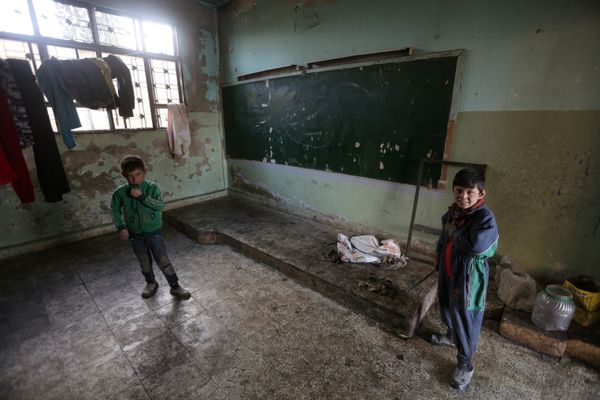 Members of Ahmed al-Abdullah's family stand near a board inside a damaged school, in rebel-held Tal-Aar village, northern Aleppo province, Syria December 28, 2016 Members of Ahmed al-Abdullah's family stand near a board inside a damaged school, in rebel-held Tal-Aar village, northern Aleppo province, Syria December 28, 2016 - Sputnik International
