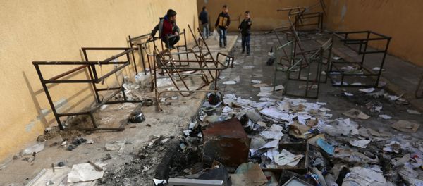 Students stand amid damaged desks and books in 'Aisha Mother of the BelieversÕ school which was recently reopened after rebels took control of al-Rai town from Islamic State militants, Syria January 17, 2017 - Sputnik International