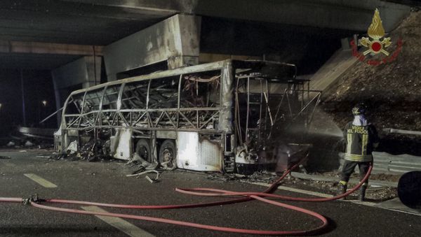 A firefighter sprays water on the burned hulk of a bus that crashed and burst into flames near Verona, northern Italy, Saturday, Jan. 21, 2017 A firefighter sprays water on the burned hulk of a bus that crashed and burst into flames near Verona, northern Italy, Saturday, Jan. 21, 2017 - Sputnik International