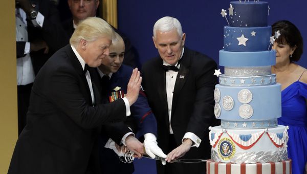 President Donald J. Trump, left, and Vice President Mike Pence, right, are helped by Coast Guard Petty Officer 2nd Class Matthew Babot, center, as they cut a cake at The Salute To Our Armed Services Inaugural Ball Friday, Jan. 20, 2017, in Washington. - Sputnik International