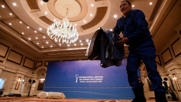 A picture taken on January 22, 2017 shows a man at work to prepare the Syria peace talks conference room at Astana' Rixos President Hotel - Sputnik International