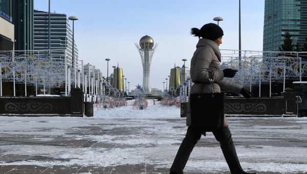 A picture taken on January 22, 2017 shows a woman walking in downtown Astana, with the Baiterek monument seen in the background A picture taken on January 22, 2017 shows a woman walking in downtown Astana, with the Baiterek monument seen in the background - Sputnik International