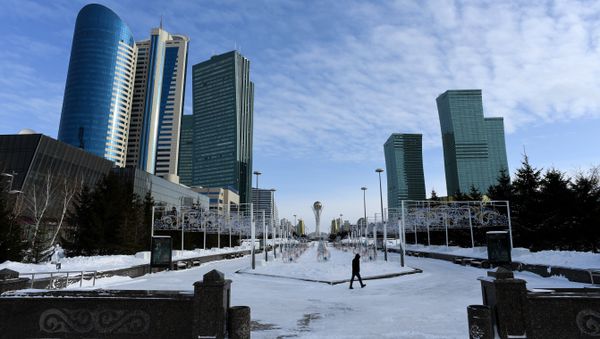 A picture taken on January 22, 2017 shows a man walking in downtown Astana, with the Baiterek monument seen in the background A picture taken on January 22, 2017 shows a man walking in downtown Astana, with the Baiterek monument seen in the background - Sputnik International