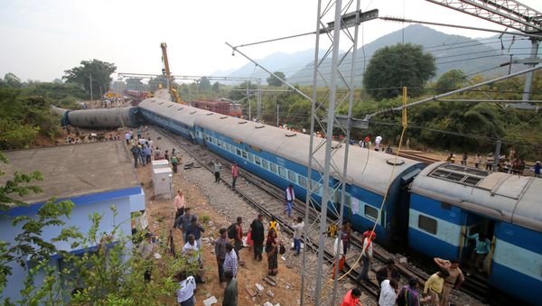 People stand near the derailed coaches of a passenger train near Kuneru village in Vizianagaram district, in the southern state of Andhra Pradesh, India, January 22, 2017 People stand near the derailed coaches of a passenger train near Kuneru village in Vizianagaram district, in the southern state of Andhra Pradesh, India, January 22, 2017 - Sputnik International