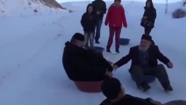 Rolling back the years: Grandpas slide down snowy slope - Sputnik International