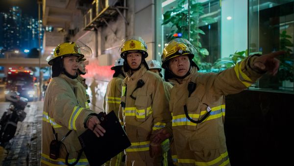 Firemen are seen near the site where a World War II-era bomb weighing almost a tonne was discovered in Hong Kong (file) Firemen are seen near the site where a World War II-era bomb weighing almost a tonne was discovered in Hong Kong (file) - Sputnik International