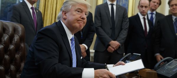 President Donald Trump looks up after signing the final of three executive orders, Monday, Jan. 23, 2017, in the Oval Office of the White House in Washington. (AP Photo/Evan Vucci) President Donald Trump looks up after signing the final of three executive orders, Monday, Jan. 23, 2017, in the Oval Office of the White House in Washington. (AP Photo/Evan Vucci) - Sputnik International