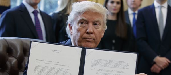 President Donald Trump shows off his signature on an executive order about the Dakota Access pipeline in the Oval Office of the White House in Washington - Sputnik International