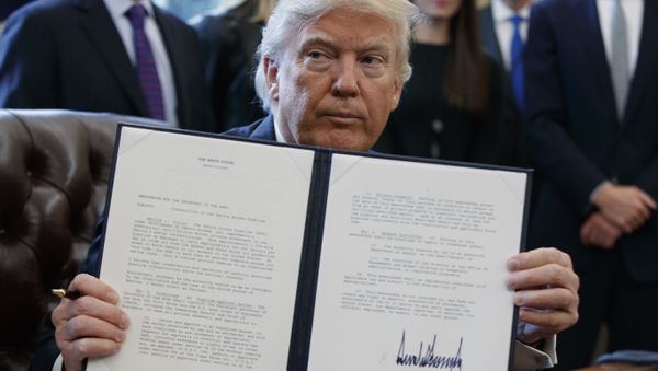 President Donald Trump shows off his signature on an executive order about the Dakota Access pipeline in the Oval Office of the White House in Washington - Sputnik International