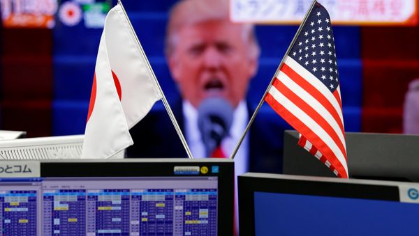 National flags of Japan and the U.S. are seen in front of a monitor showing U.S. President Donald Trump at a foreign exchange trading company in Tokyo, Japan, January 23, 2017 National flags of Japan and the U.S. are seen in front of a monitor showing U.S. President Donald Trump at a foreign exchange trading company in Tokyo, Japan, January 23, 2017 - Sputnik International