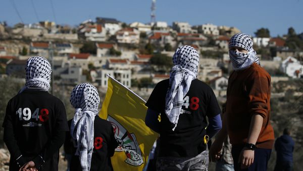 Palestinian protestors stand facing the Israeli settlement of Qadumim (Kedumim) during clashes with Israeli security forces following a demonstration against the expropriation of Palestinian land by Israel in the village of Kfar Qaddum, near Nablus, in the occupied West Bank on December 30, 2016 Palestinian protestors stand facing the Israeli settlement of Qadumim (Kedumim) during clashes with Israeli security forces following a demonstration against the expropriation of Palestinian land by Israel in the village of Kfar Qaddum, near Nablus, in the occupied West Bank on December 30, 2016 - Sputnik International