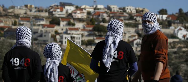 Palestinian protestors stand facing the Israeli settlement of Qadumim (Kedumim) during clashes with Israeli security forces following a demonstration against the expropriation of Palestinian land by Israel in the village of Kfar Qaddum, near Nablus, in the occupied West Bank on December 30, 2016 Palestinian protestors stand facing the Israeli settlement of Qadumim (Kedumim) during clashes with Israeli security forces following a demonstration against the expropriation of Palestinian land by Israel in the village of Kfar Qaddum, near Nablus, in the occupied West Bank on December 30, 2016 - Sputnik International