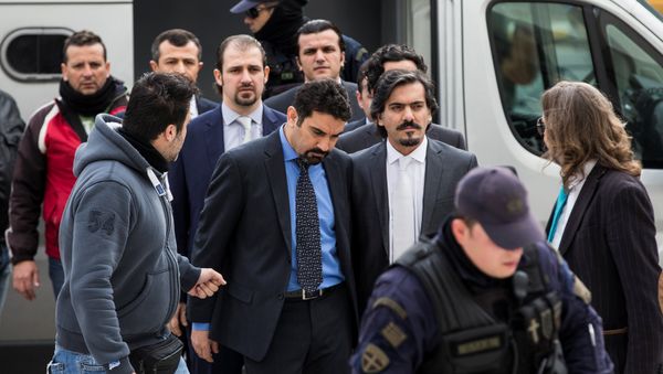 The eight Turkish soldiers, who fled to Greece in a helicopter and requested political asylum after a failed military coup against the government, are escorted by police officers as they arrive at the Supreme Court in Athens, Greece, January 26, 2017 The eight Turkish soldiers, who fled to Greece in a helicopter and requested political asylum after a failed military coup against the government, are escorted by police officers as they arrive at the Supreme Court in Athens, Greece, January 26, 2017 - Sputnik International