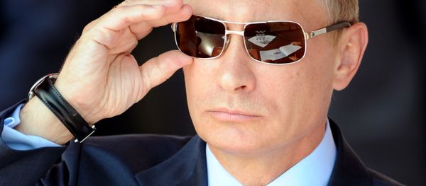 Russian Prime Minister Vladimir Putin adjusts his sunglasses as he watches an air show during MAKS-2011, the International Aviation and Space Show, in Zhukovsky, outside Moscow, on August 17, 2011 Russian Prime Minister Vladimir Putin adjusts his sunglasses as he watches an air show during MAKS-2011, the International Aviation and Space Show, in Zhukovsky, outside Moscow, on August 17, 2011 - Sputnik International