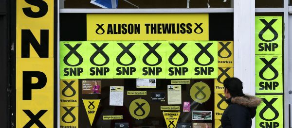 A member of the public walks past a window display of Scottish National Party branding is displayed in Glasgow, Scotland, Thursday, May 7, 2015 A member of the public walks past a window display of Scottish National Party branding is displayed in Glasgow, Scotland, Thursday, May 7, 2015 - Sputnik International