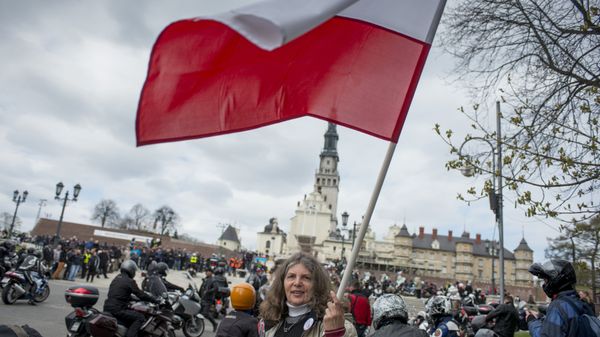 A woman waves a Polish flag in front of the Jasna Gora monastery during the annual Polish motorcyclists pilgrimage to the country's greatest place of pilgrimage hosting the Black Madonna of Czestochowa in Czestochowa, Poland, on April 19, 2015 A woman waves a Polish flag in front of the Jasna Gora monastery during the annual Polish motorcyclists pilgrimage to the country's greatest place of pilgrimage hosting the Black Madonna of Czestochowa in Czestochowa, Poland, on April 19, 2015 - Sputnik International