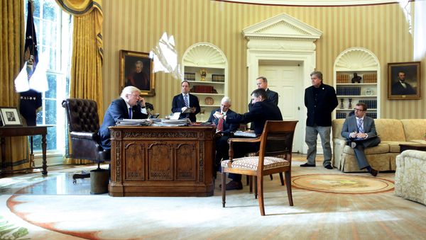 U.S. President Donald Trump (from L), joined by Chief of Staff Reince Priebus, Vice President Mike Pence, National Security Advisor Michael Flynn, Communications Director Sean Spicer and senior advisor Steve Bannon, speaks by phone with Russia's President Vladimir Putin in the Oval Office at the White House in Washington, U.S. January 28, 2017 - Sputnik International