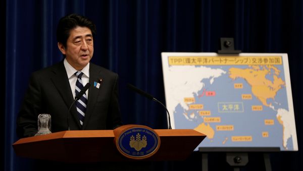 Japan's Prime Minister Shinzo Abe speaks next to a map showing participating countries in rule-making negotiations for the Trans-Pacific Partnership (TPP) during a news conference at his official residence in Tokyo (File) - Sputnik International