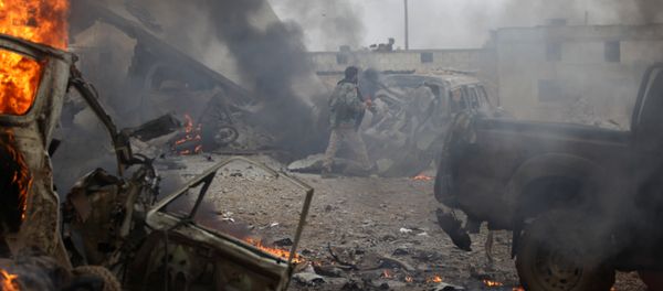 A rebel fighter walks near damaged vehicles after a car bomb explosion in Jub al Barazi east of the northern Syrian town of al-Bab, Syria January 15, 2017 - Sputnik International