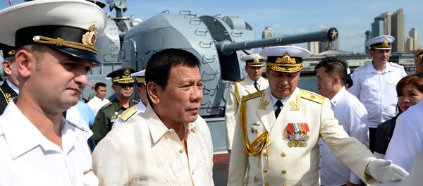 Russia's Rear Admiral Eduard Mikhailov (R) leads the way as he guides Philippines' President Rodrigo Duterte (2nd L) onboard the Russian anti-submarine navy ship Admiral Tributs in Manila on January 6, 2017 Russia's Rear Admiral Eduard Mikhailov (R) leads the way as he guides Philippines' President Rodrigo Duterte (2nd L) onboard the Russian anti-submarine navy ship Admiral Tributs in Manila on January 6, 2017 - Sputnik International