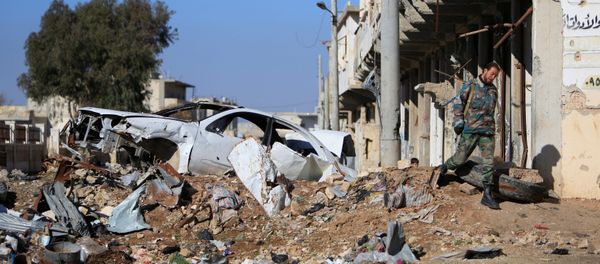A Syrian government soldier walks near a damaged car on a road to Aleppo, Syria January 29, 2017 A Syrian government soldier walks near a damaged car on a road to Aleppo, Syria January 29, 2017 - Sputnik International