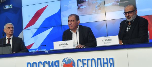 Qadri Jamil, center, chairman of the Syrian opposition's Moscow group, secretary of the People's Will Party and one of the leaders of the Popular Front for Change and Liberation, with Jamal Suleiman, right, a representative of the Syrian opposition's Cairo group, during a news conference at the Rossiya Segodnya International Multimedia Press Center in Moscow - Sputnik International
