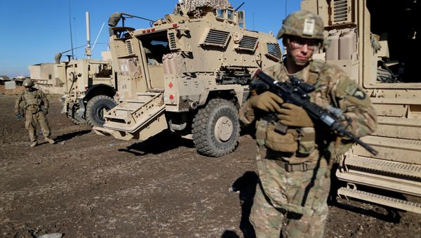 US army soldiers stand next a military vehicle in the town of Bartella, east of Mosul, Iraq, December 27, 2016 - Sputnik International