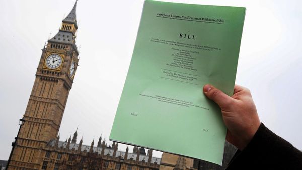 A journalist poses with a copy of the Brexit Article 50 bill, introduced by the government to seek parliamentary approval to start the process of leaving the European Union, in front of the Houses of Parliament in London, Britain, January 26, 2017. - Sputnik International