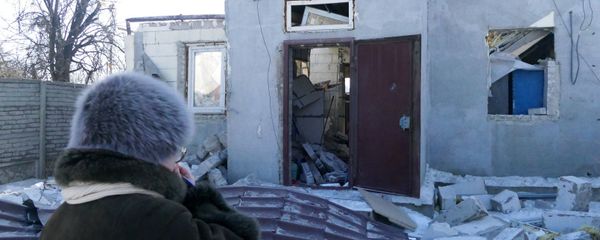 A woman by a house damaged by the shelling of the Ukrainian army in Makeevka, Donetsk Region - Sputnik International