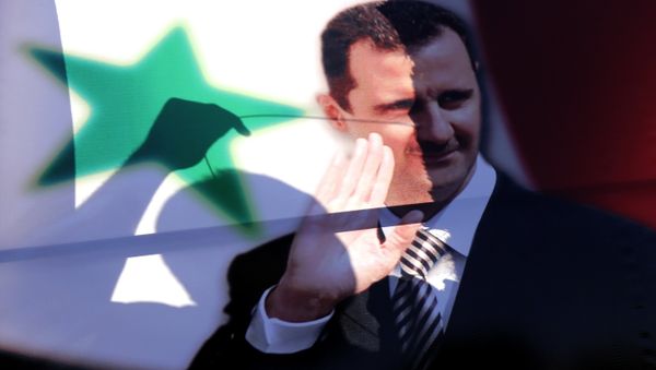 The silhouette of a Syrian man is seen through an election campaign portrait of President Bashar al-Assad he hangs it on a billboard on May 11, 2014 in the capital Damascus. - Sputnik International