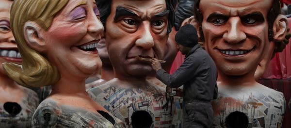 A man puts the final touche on a giant figure depicting right-wing presidential candidates Francois Fillon (C) next to others depicting far right presidential candidate Marine Le Pen (L) and centrist independent presidential candidate Emmanuel Macron, on January 27, 2017 in Nice, southeastern France. A man puts the final touche on a giant figure depicting right-wing presidential candidates Francois Fillon (C) next to others depicting far right presidential candidate Marine Le Pen (L) and centrist independent presidential candidate Emmanuel Macron, on January 27, 2017 in Nice, southeastern France. - Sputnik International