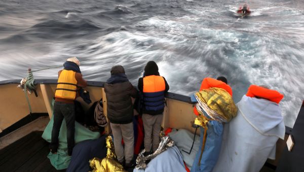 Migrants are seen at the stern of the former fishing trawler Golfo Azzurro of the Spanish NGO Proactiva Open Arms, a day after they were rescued along with other migrants near the coasts of Libya, in the central Mediterranean Sea, January 28, 2017. Migrants are seen at the stern of the former fishing trawler Golfo Azzurro of the Spanish NGO Proactiva Open Arms, a day after they were rescued along with other migrants near the coasts of Libya, in the central Mediterranean Sea, January 28, 2017. - Sputnik International