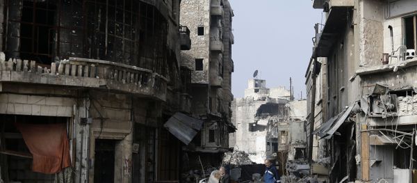 Syrians walk through the destruction in the old city of Aleppo, Syria Syrians walk through the destruction in the old city of Aleppo, Syria - Sputnik International