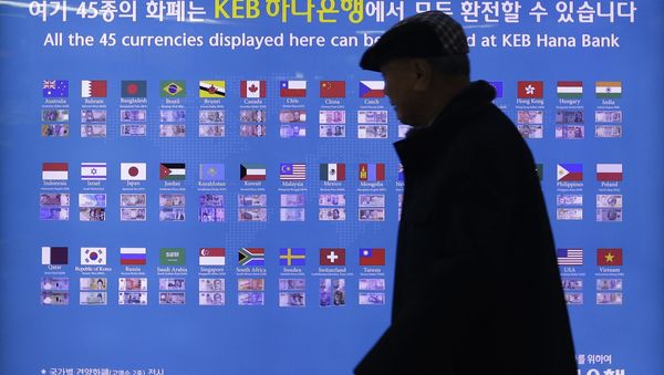 A man walks by a board displaying various banknotes issued in the world at a subway station in Seoul, South Korea. A man walks by a board displaying various banknotes issued in the world at a subway station in Seoul, South Korea. - Sputnik International