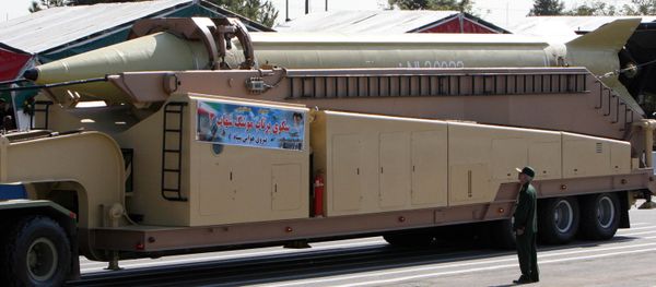 A member of Iranian Corps Guards of the Islamic Revolution forces looks at a Shahab 3 missile during large-scale military parades in Tehran (File) - Sputnik International