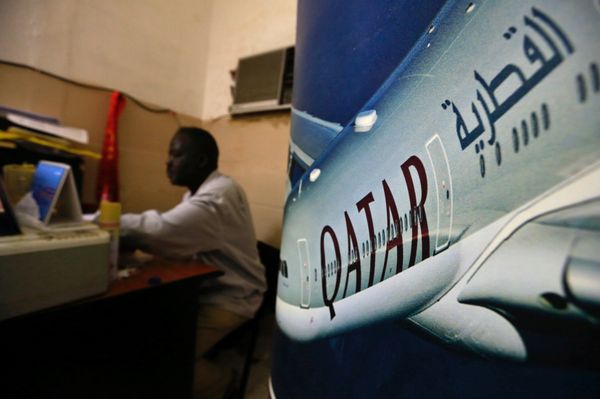 An image of a Qatar Airways plane is seen near an employee working at a travel agency in Khartoum, Sudan January 28, 2017 An image of a Qatar Airways plane is seen near an employee working at a travel agency in Khartoum, Sudan January 28, 2017 - Sputnik International