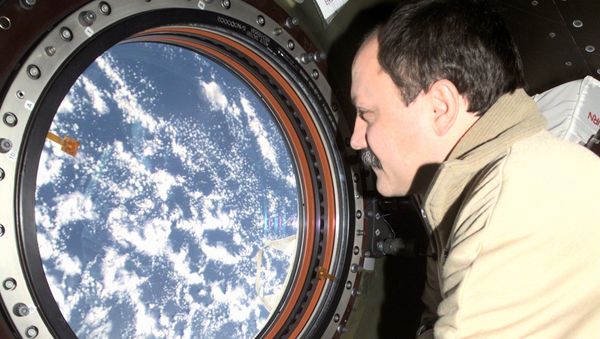 Cosmonaut Yury V. Usachev, Expedition Two mission commander, looks through the window on the Destiny laboratory onboard the International Space Station (ISS). - Sputnik International