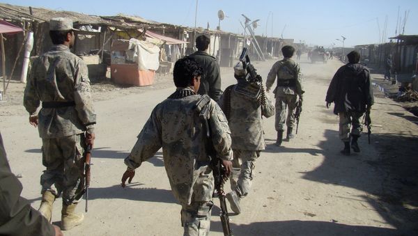 Afghan troops walk through the village of Laki , in Helmand province's Garmsir district, south of Kabul, Afghanistan (File) - Sputnik International